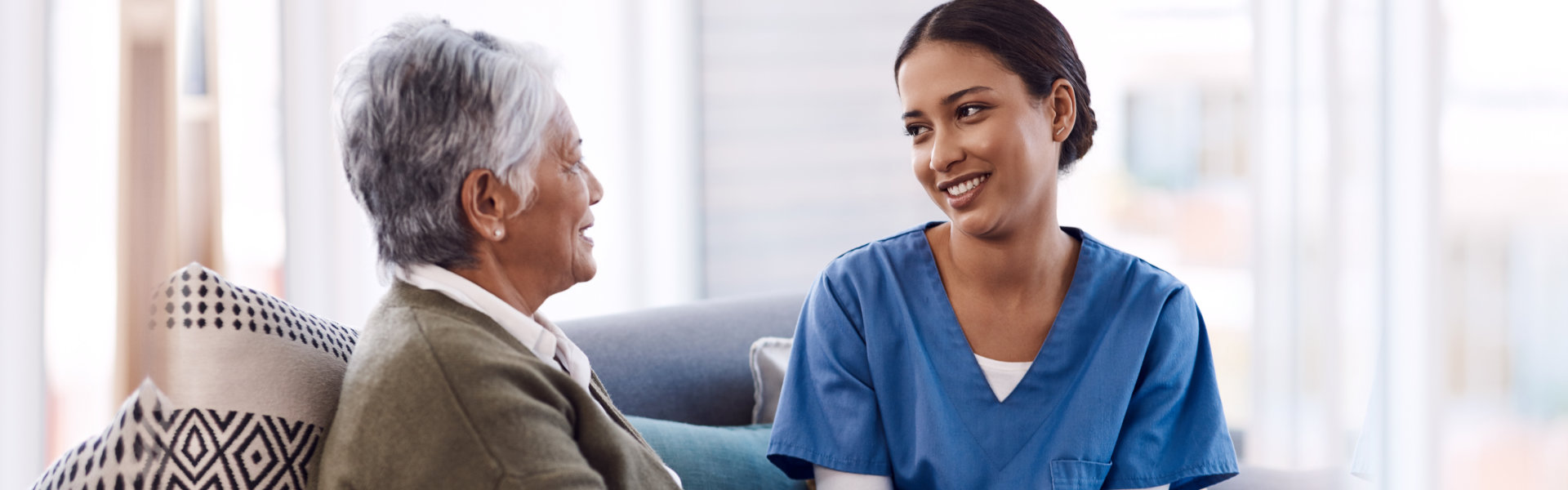 elderly woman and nurse talking