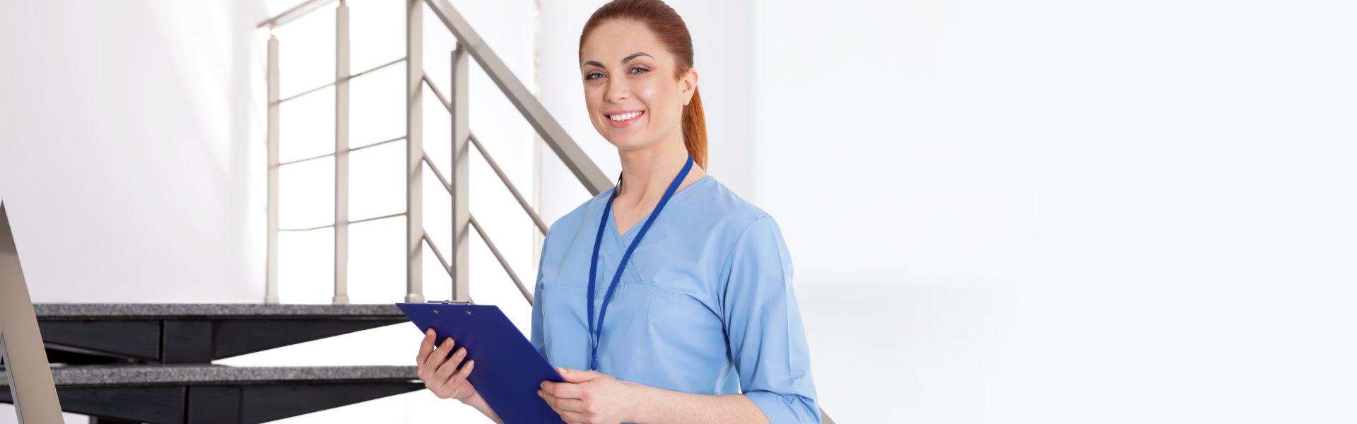 nurse holding folder and smiling